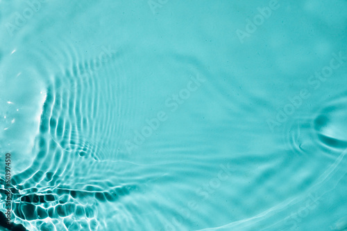 Trendy summer nature background with water waves and sunlight. Transparent clear water surface texture. 