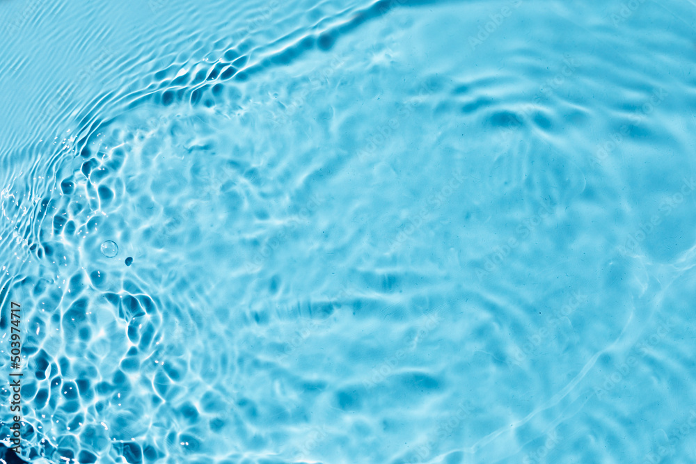 Liquid colored clear water surface texture with splashes bubbles. Blue water waves in sunlight background. Liquid colored clear water surface texture with splashes bubbles. Blue water waves in sunlight background.