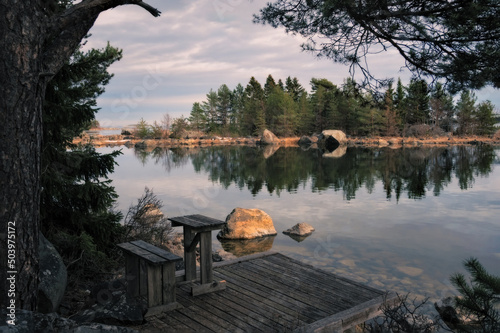 A little jetty with view on the sea,  isles and floating rocks in the Gulf of Bothnia at dusk.
 photo