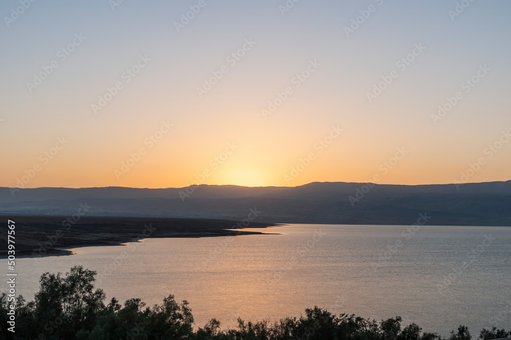 Orange sunrise reflecting off of the Dead Sea. High quality photo