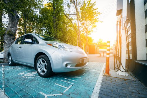 Electric car on charging spot in a residential area of the city photo