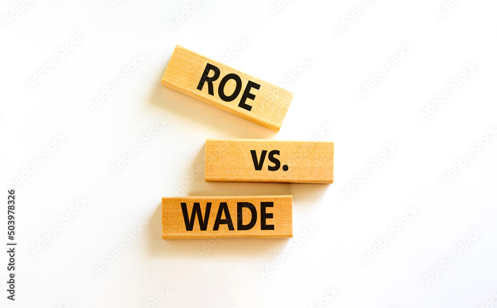 Abortion process Roe versus Wade symbol. Concept words Roe versus Wade on wooden blocks. Beautiful white table white background. Abortion process Roe versus Wade concept. Copy space.