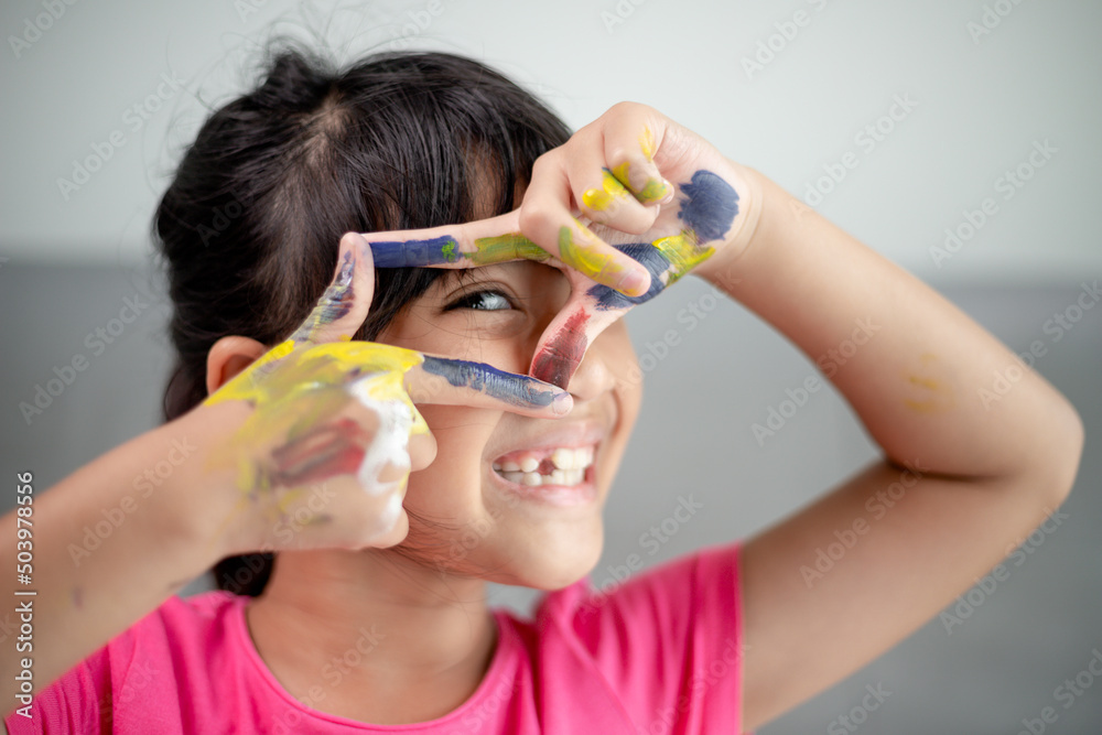 education, school, art and painitng concept - little student girl showing painted hands education, school, art and painitng concept - little student girl showing painted hands