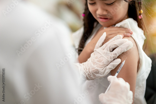 Successful covid-19 vaccination. cute little girl while being immunized against coronavirus