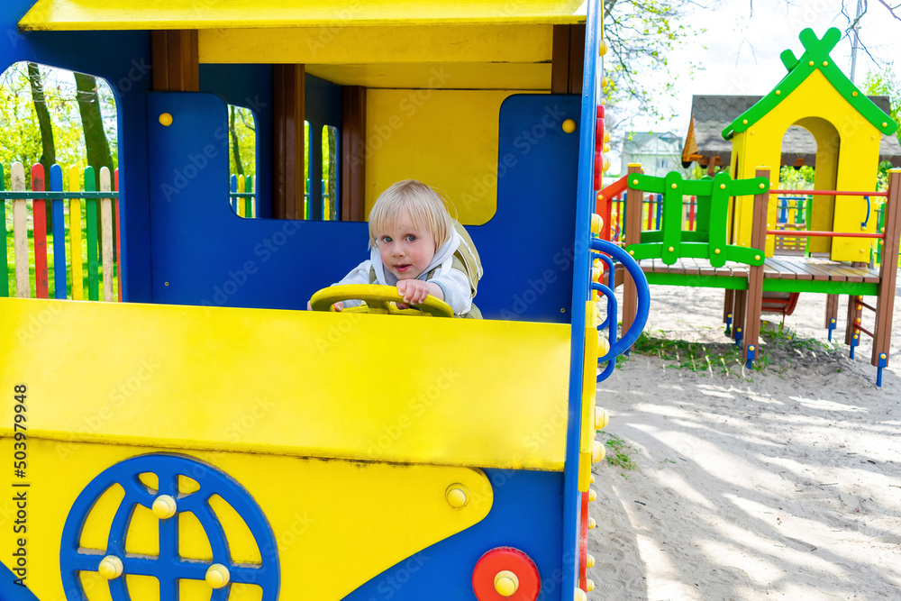 Kidd Rding Inside A Shuttle Cute funny blond little young toddler kid child boy sitting and riding ...