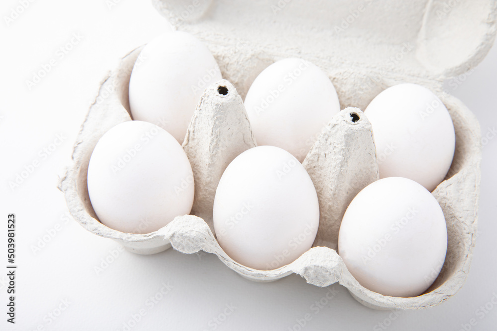 Organic packaging of white chicken eggs isolated on white background. Organic product. Organic packaging of white chicken eggs isolated on white background. Organic product.