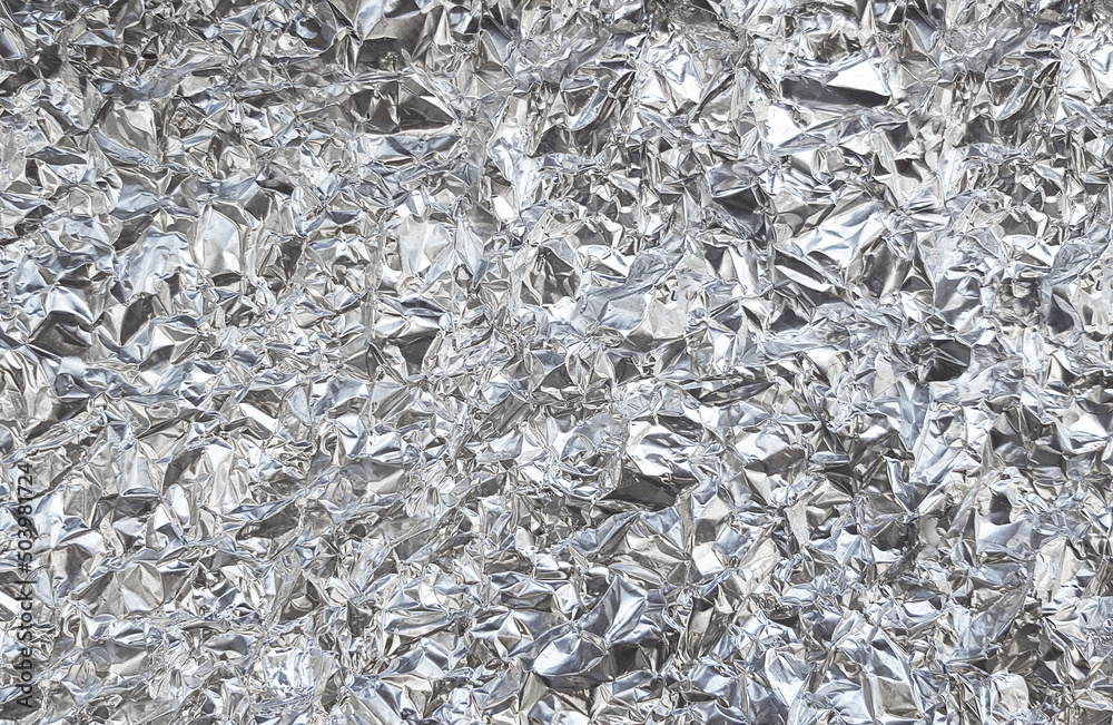 Silver foil with shiny crumpled surface texture background Silver foil with shiny crumpled surface texture background