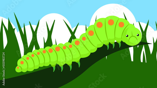 Caterpillar on green grass against the blue sky