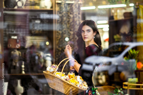 Beautiful Ukrainian girl with a basket of flowers.