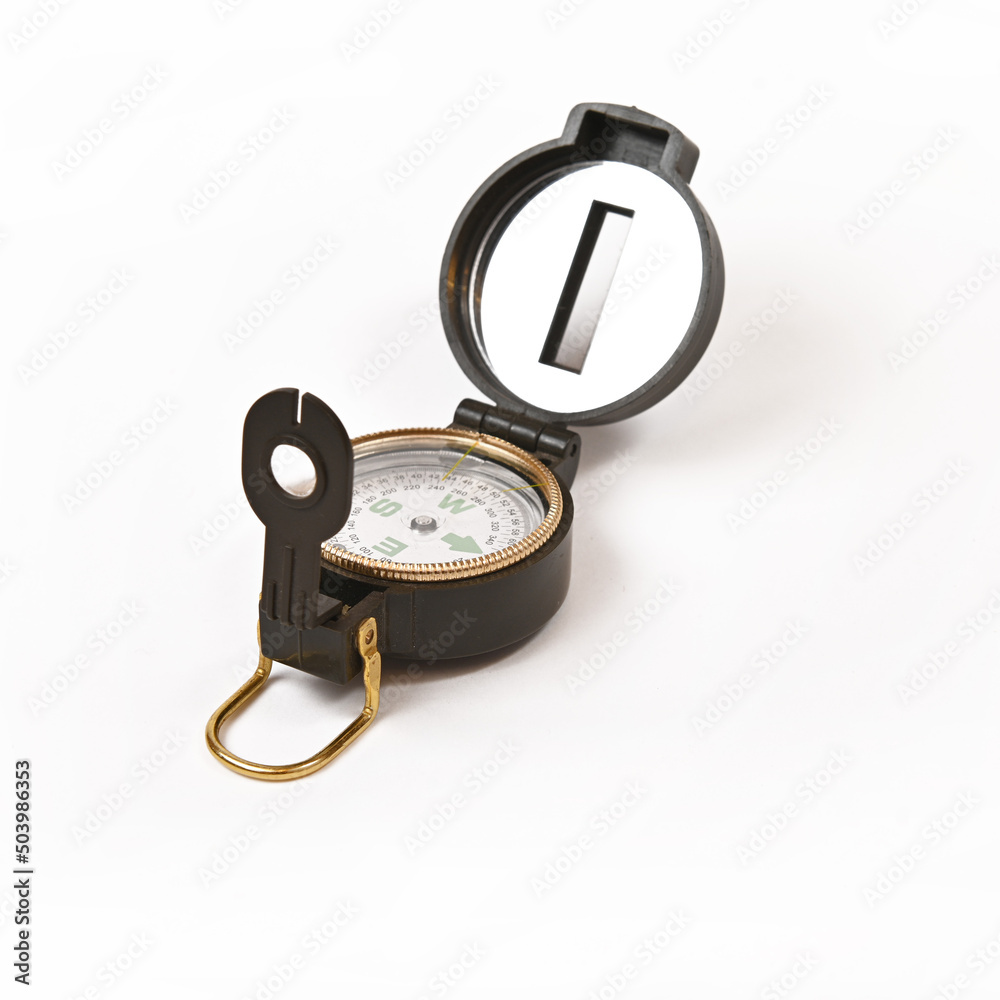 Tourist magnetic compass with a heliograph on a white background.Isolate. Tourist magnetic compass with a heliograph on a white background.Isolate.