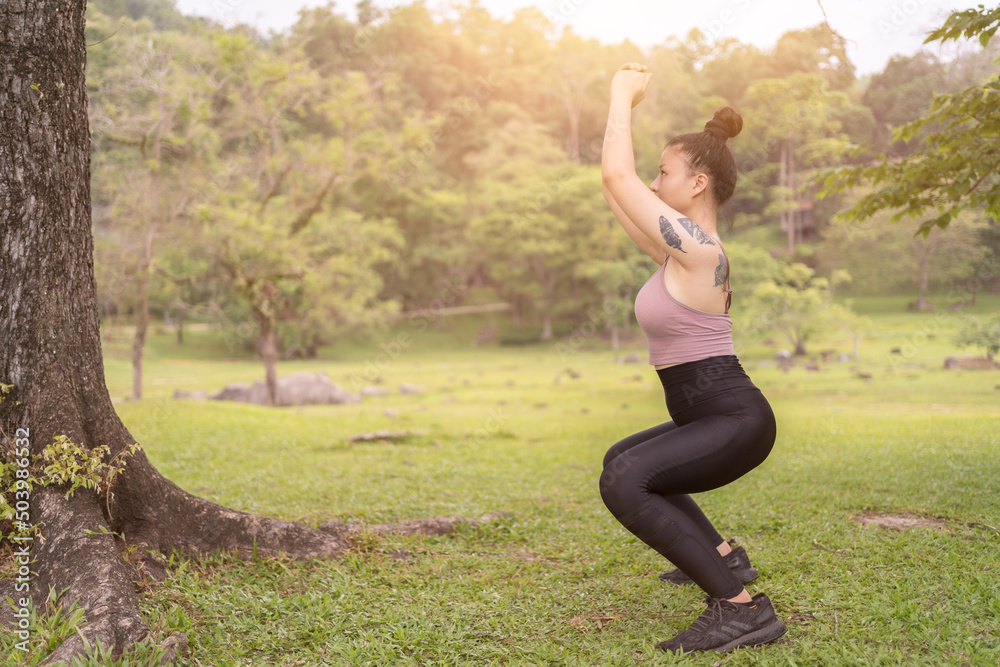 asian tattoo young woman doing yoga in the park asian tattoo young woman doing yoga in the park