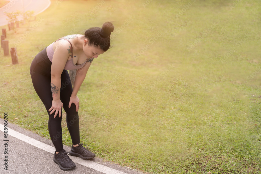 tired woman runner taking a rest after running hard tired woman runner taking a rest after running hard