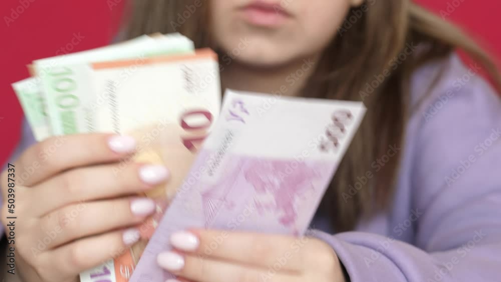 Close-up of a caucasian girl holding cash euro banknotes in her hands.Cash. Inflation is the devaluation of the European currency. financial crisis in Europe. selective focus Close-up of a caucasian girl holding cash euro banknotes in her hands.Cash. Inflation is the devaluation of the European currency. financial crisis in Europe. selective focus