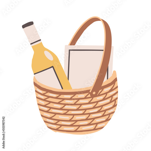 Wine and a book in a wicker basket. Picnic set in a straw bag