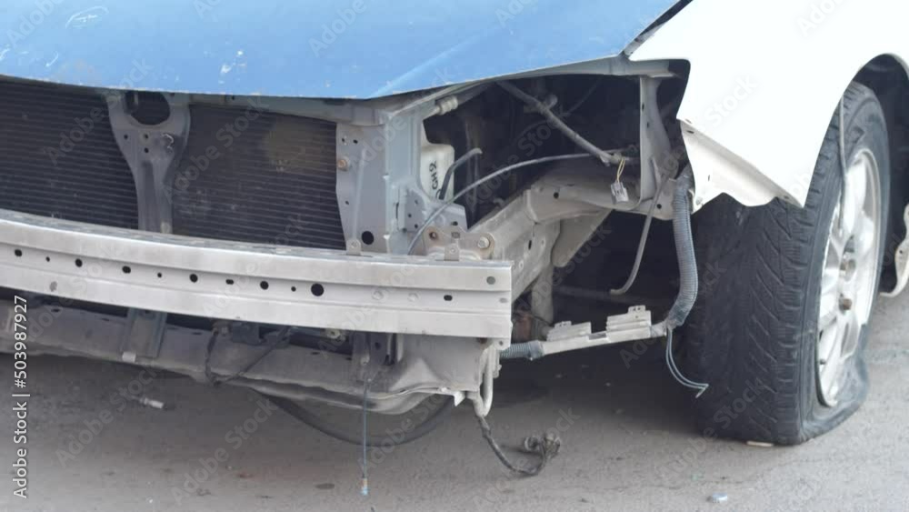 Car insurance theme. A crashed car with a missing bumper. Road incident