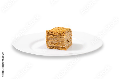 A piece of cake, layered on a white plate on a clean white background.
