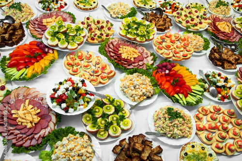 delicious dishes on the festive table. different food on the wedding table. the concept of celebrating an important event. buffet table with sandwiches and cold cuts