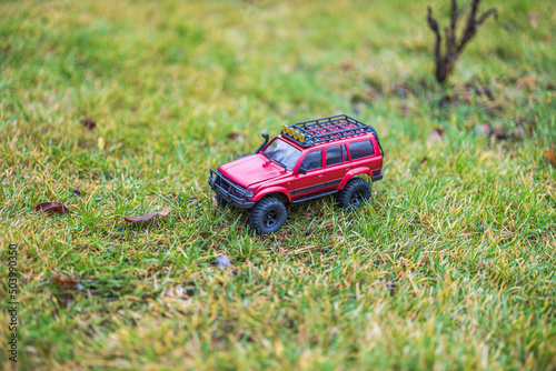 Close up view of toy radio controlled SUV model standing on green grass. Sweden.