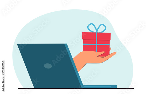 Hand coming out of laptop screen and holding gift box. Loyalty program or delivery flat vector illustration. Birthday or holidays, online shopping concept for banner, website design or landing page
