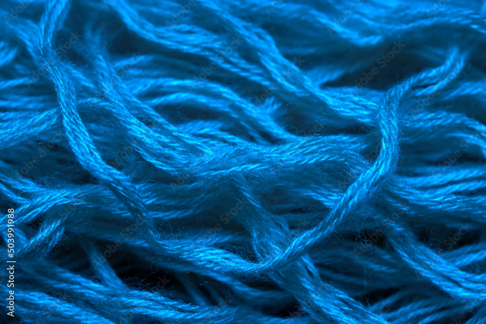 Fototapeta premium Blue threads of wool close up. Texture of woolen threads for knitting.