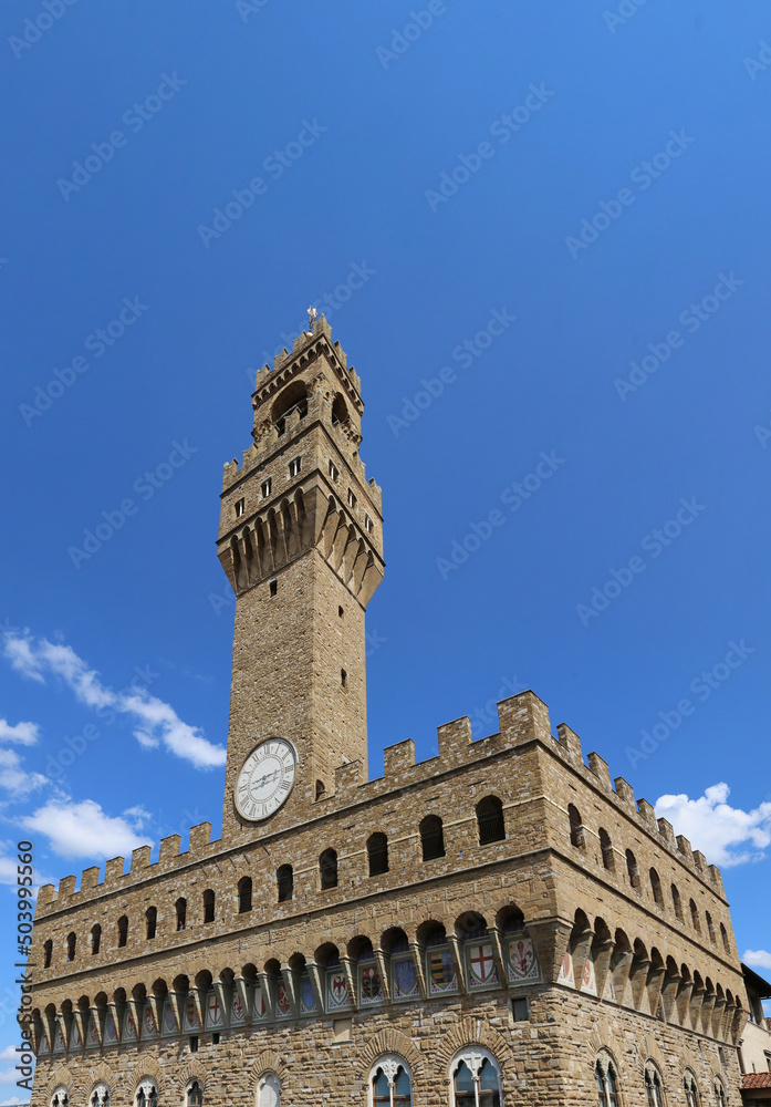 TOWER OF OLD PALACE called Palazzo Vecchio in Italian language in Florence City in Italy in Tuscany Region in Europe and blue sky