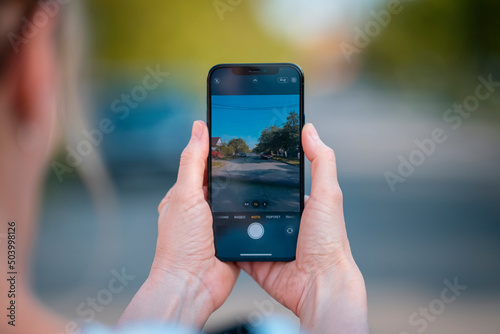 Woman hand holding camera phone and takes photos