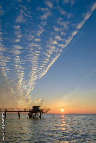 Fotografi Wooden fishing hut at sunset on coast of La Rochelle, Charente Maritime, France