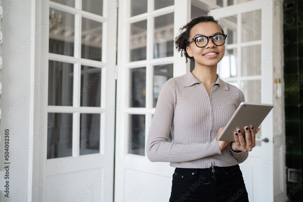 A millennial freelance woman works in an office using a laptop to surf the internet. A millennial freelance woman works in an office using a laptop to surf the internet.