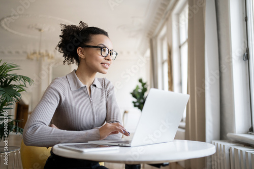 Online training a smart woman with glasses uses the school's website, a video call via the Internet