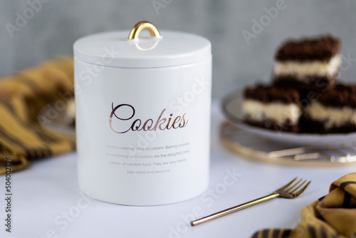 Canvas White ceramic cookie jar on grey background with cookies in the background