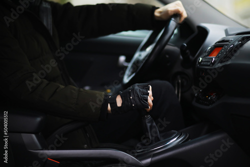 Hand on the car gear knob. The driver switches the speed in the car. Hand on gear lever. © alexkich