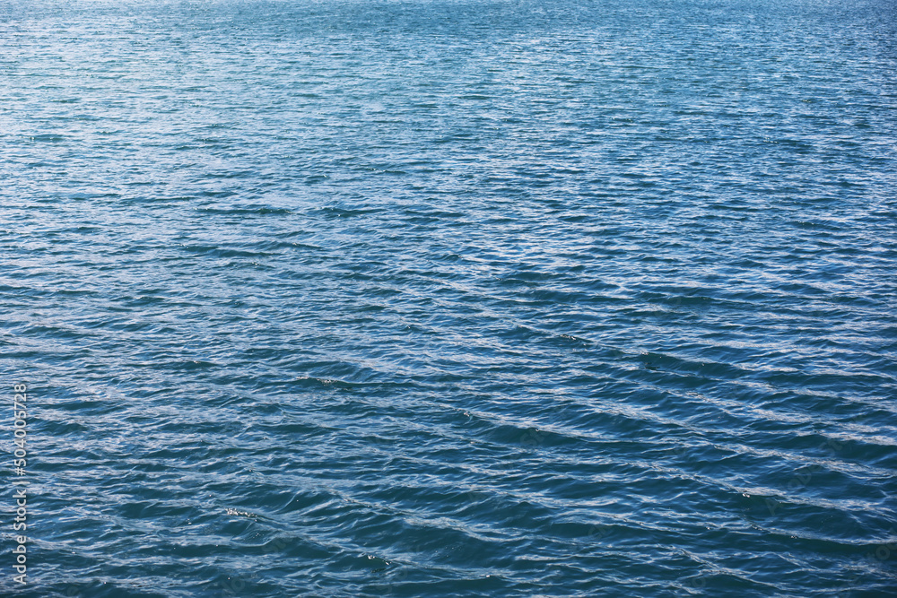 Water surface. The texture of the water. Waves on the lake in windy weather. Water surface. The texture of the water. Waves on the lake in windy weather.
