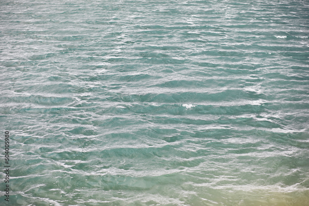 Water surface. The texture of the water. Waves on the lake in windy weather. Water surface. The texture of the water. Waves on the lake in windy weather.