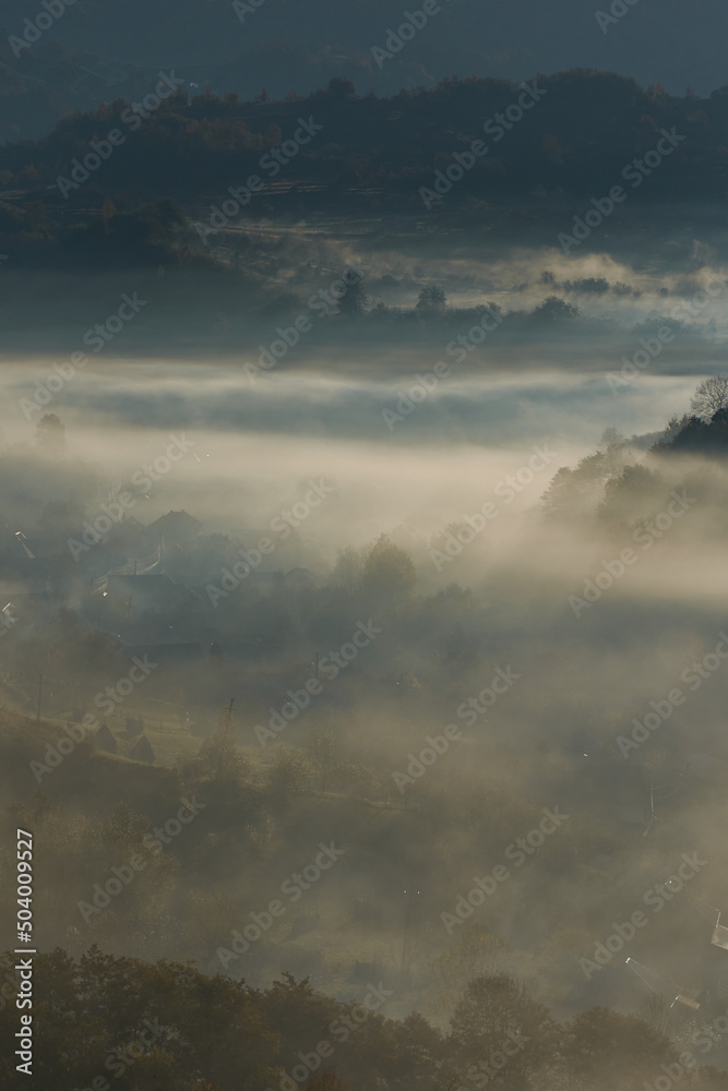 Beautiful mystical landscape over the forests and hills after the sunrise. Misty morning. Fairytale atmosphere