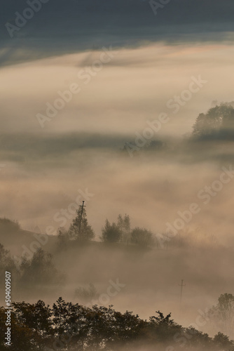 Beautiful mystical landscape over the forests and hills after the sunrise. Misty morning