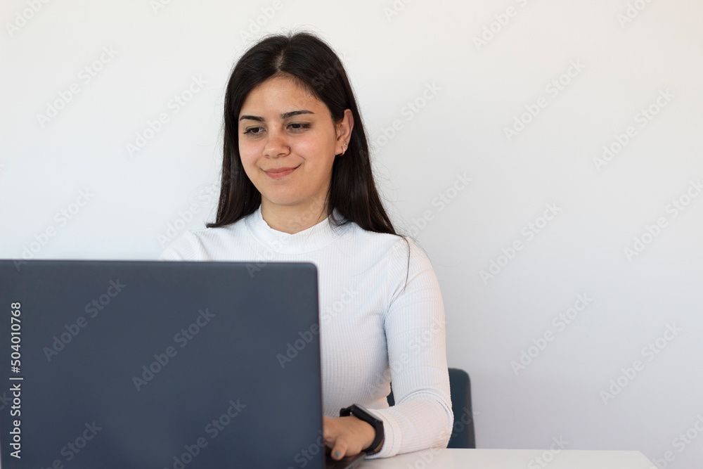 young woman working at computer and smiling young woman working at computer and smiling