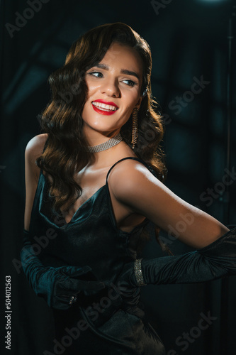 Portrait of beautiful woman in classic retro look. Brunette girl in vintage Hollywood movie style with makeup, hairstyle and jewelry