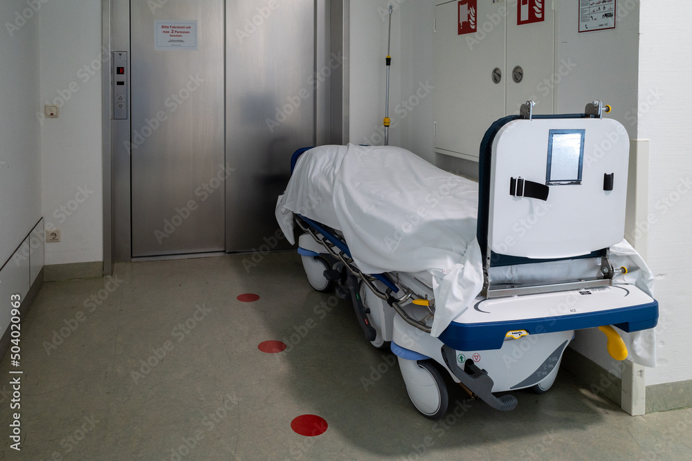 patient transport bed stands in front of an elevator in a hospital patient transport bed stands in front of an elevator in a hospital