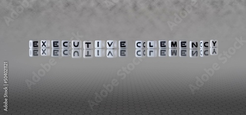 Photography executive clemency word or concept represented by black and white letter cubes o