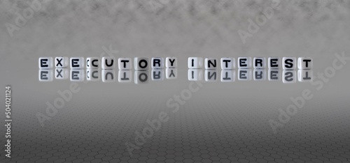 executory interest word or concept represented by black and white letter cubes on a grey horizon background stretching to infinity