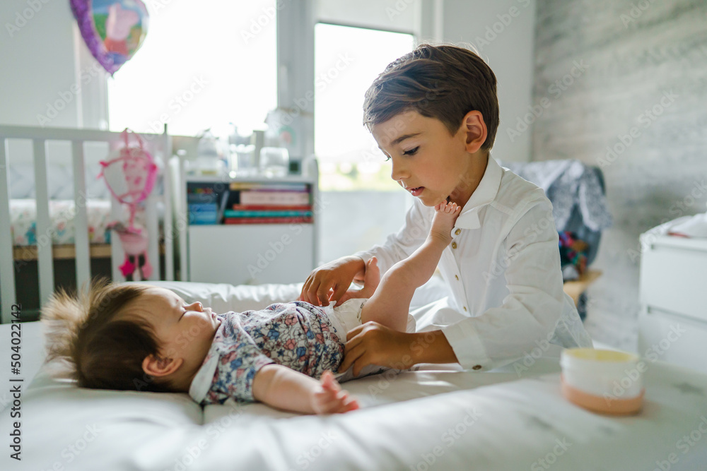 Sister changing clothes in front of brother