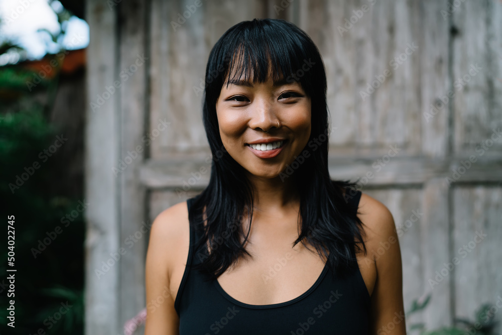 Fototapeta premium Portrait of smiling asian girl looking at camera