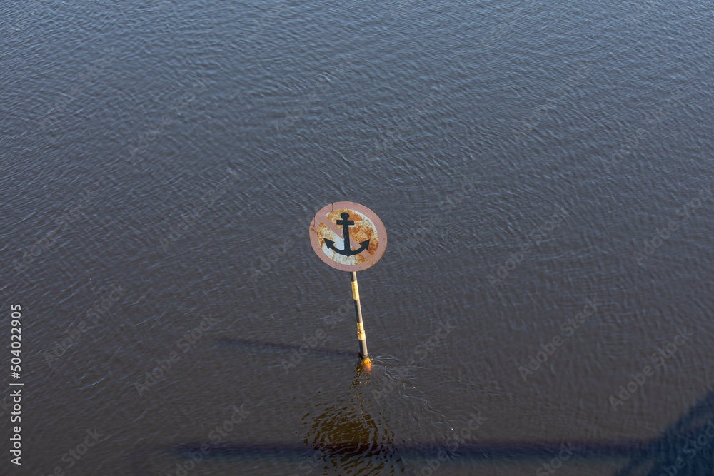 A sign on the river in the water. A sign on the river in the water.