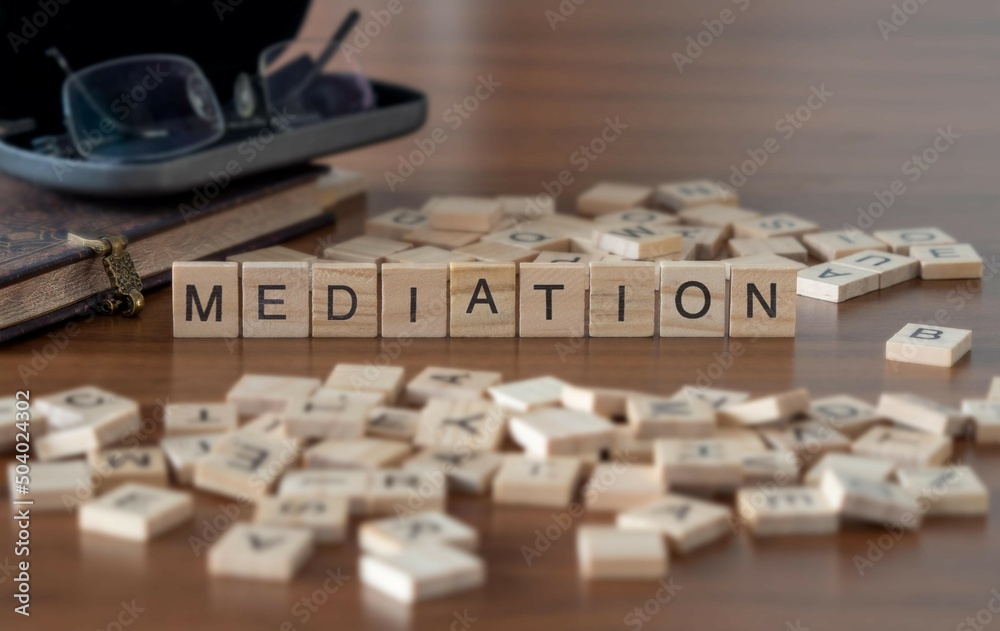 mediation word or concept represented by wooden letter tiles on a wooden table with glasses and a book - obrazy, fototapety, plakaty 