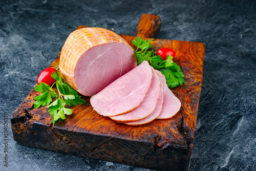 Konstfotografi Traditional German boiled Easter ham with tomatoes and parsley offered as close-