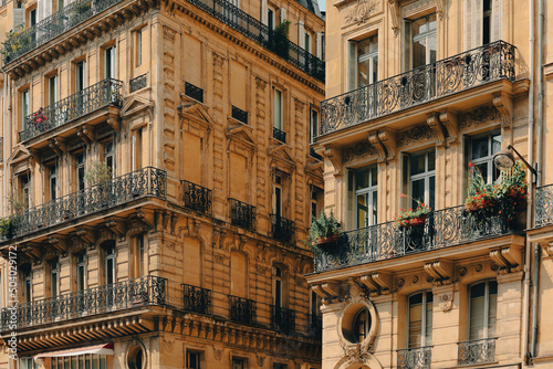 Facade of a traditional living building with large windows and balconies in Paris in France