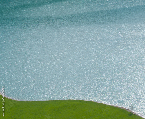 green grass and blue lake