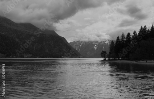 Lake with mountains in grayscale