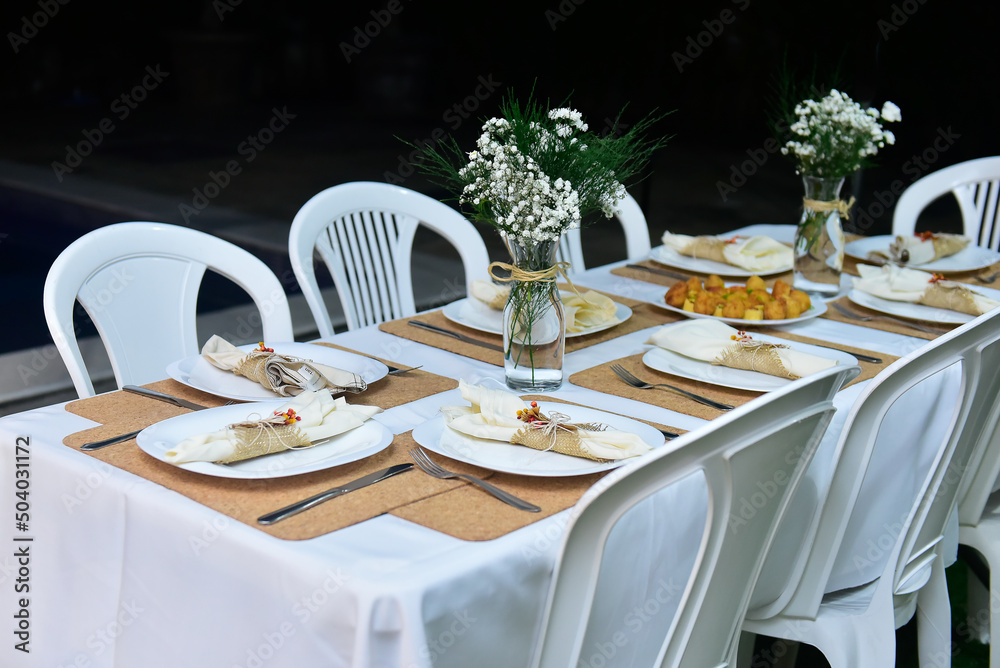 table set for a dinner, ornamental flowers, birthday party