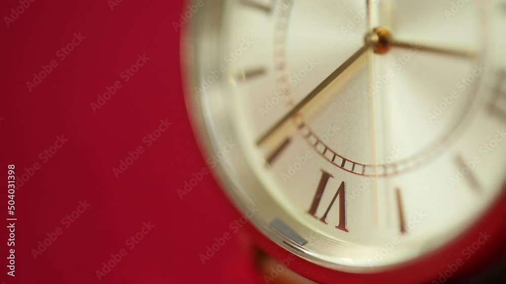 gold metallic second on clock face. Red background for copy space. macro watch. gold metallic second on clock face. Red background for copy space. macro watch.